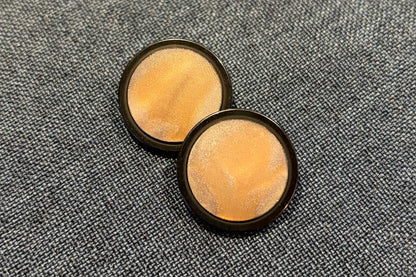 Two buttons with black edge and golden centres