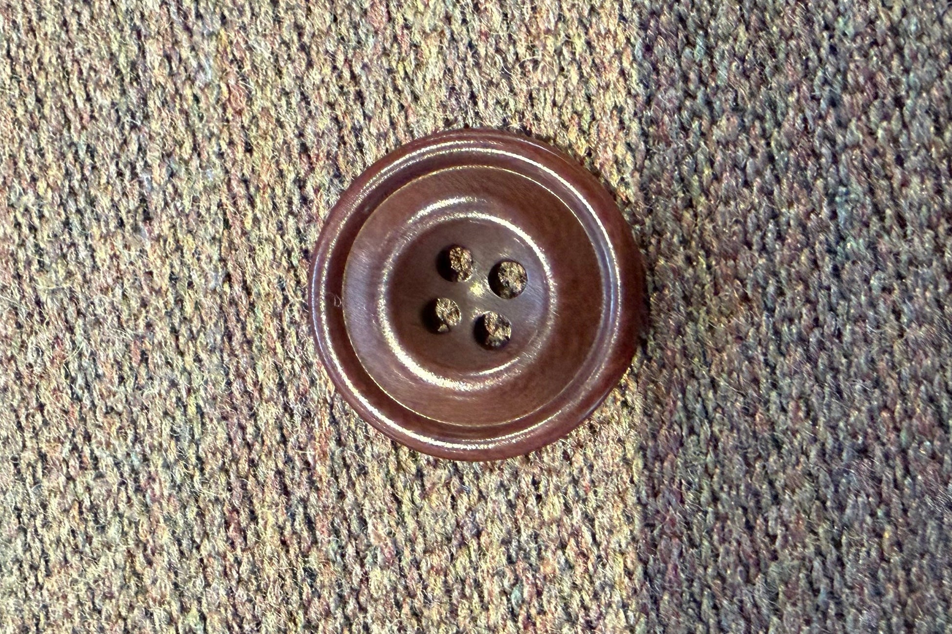 Brown button on a textured fabric background