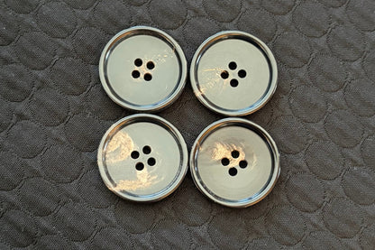 Set of polished black buttons on a textured black surface