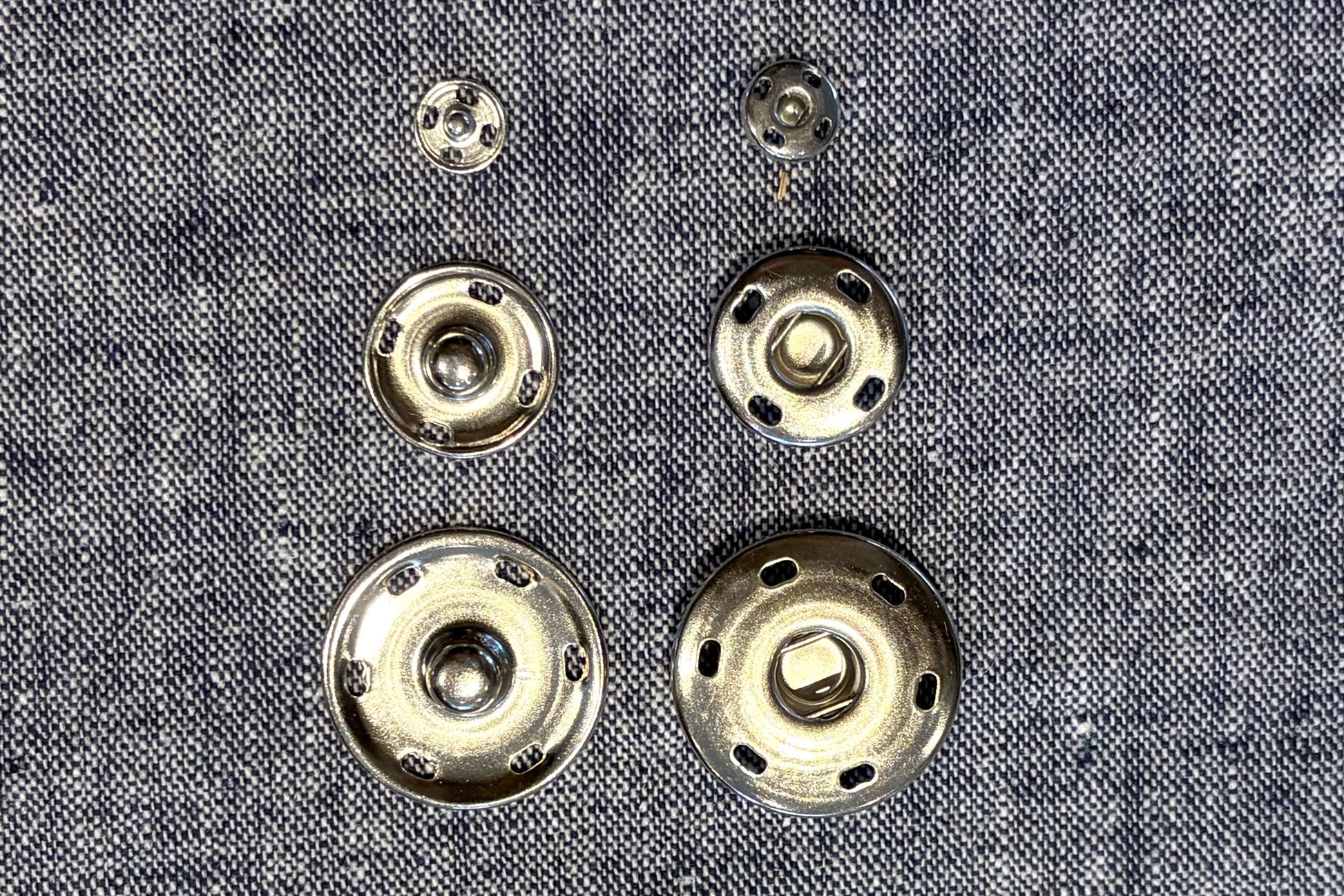 Metal buttons on a textured fabric background