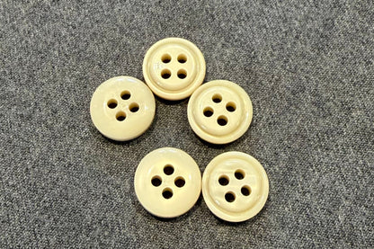 Five white buttons on a textured gray surface
