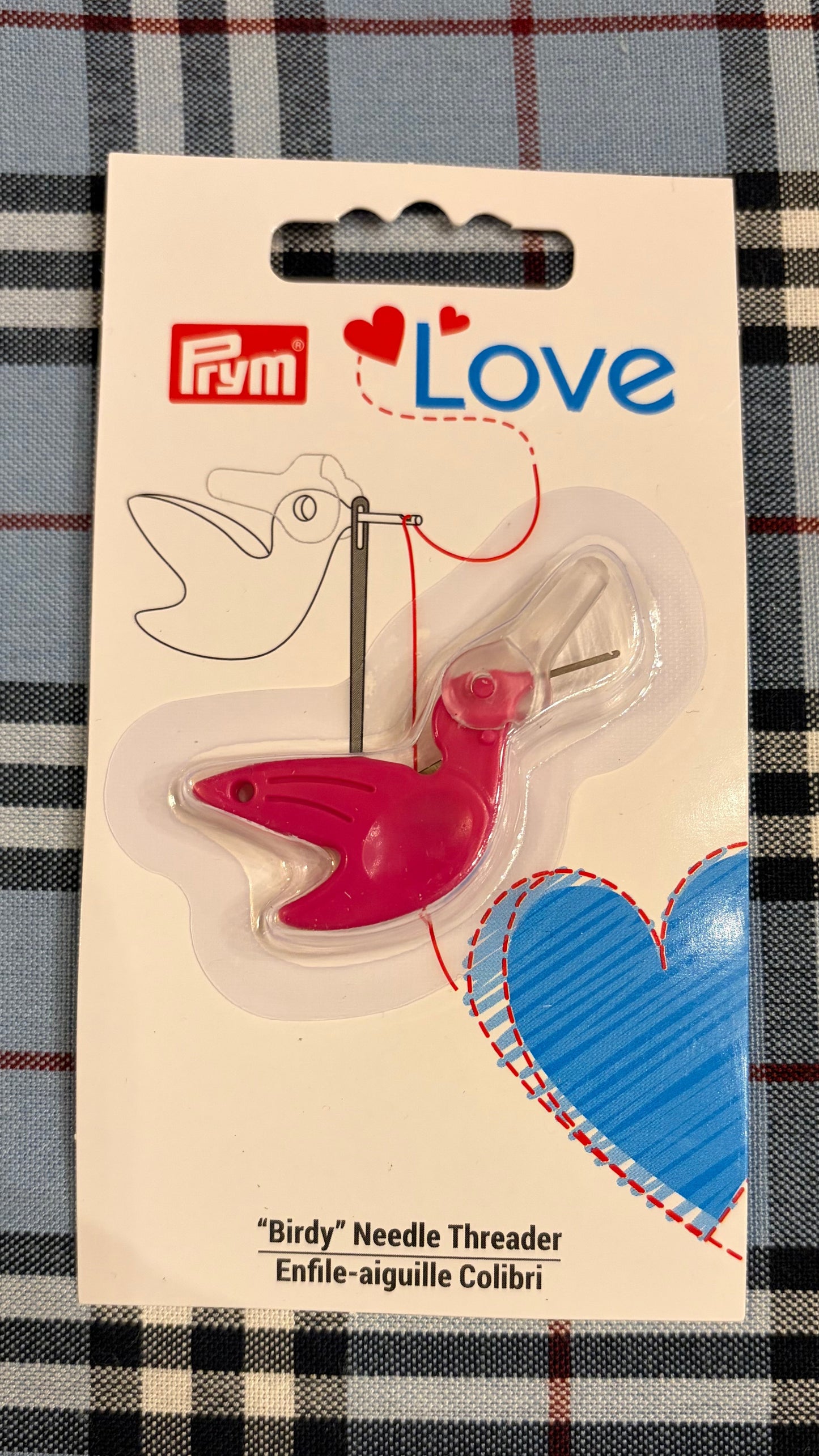  Prym Love bird-shaped needle threader on a plaid background