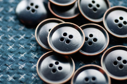 Close-up of blue buttons on a textured fabric background