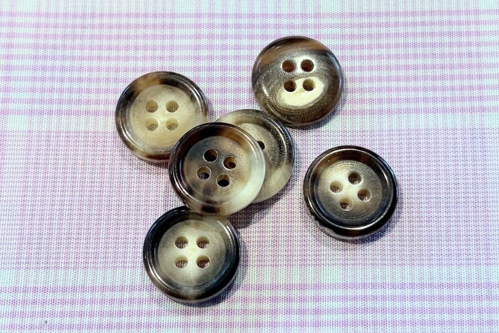 Close-up of buttons on a textured fabric background