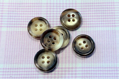 Close-up of buttons on a textured fabric background