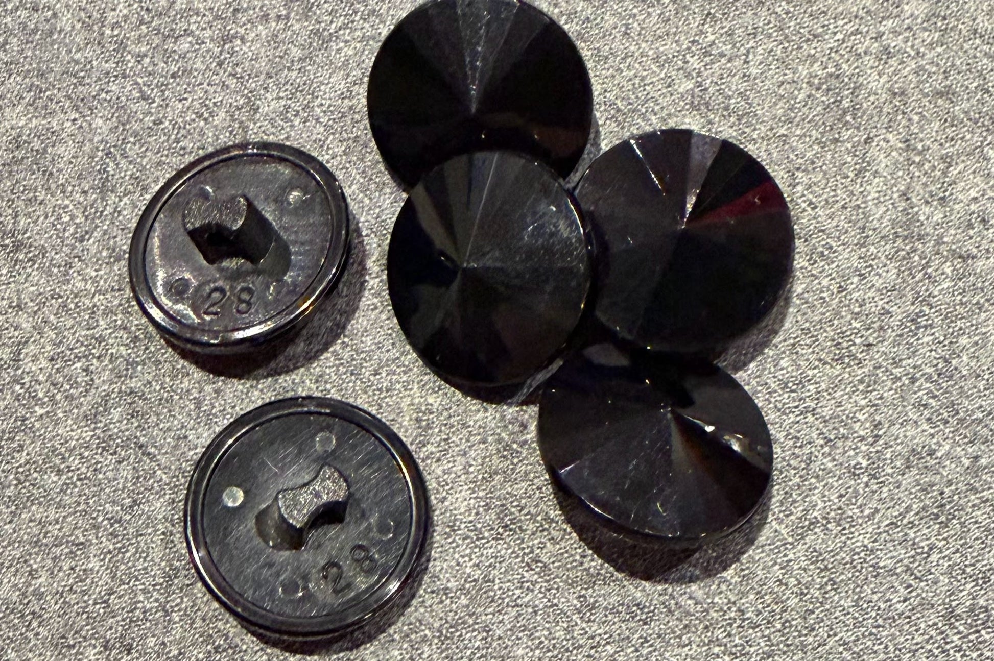 Black buttons on a textured gray surface