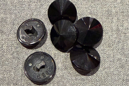 Black buttons on a textured gray surface