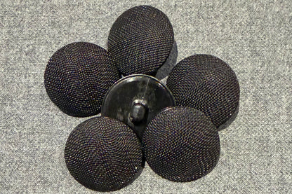 Black mesh buttons on a gray surface